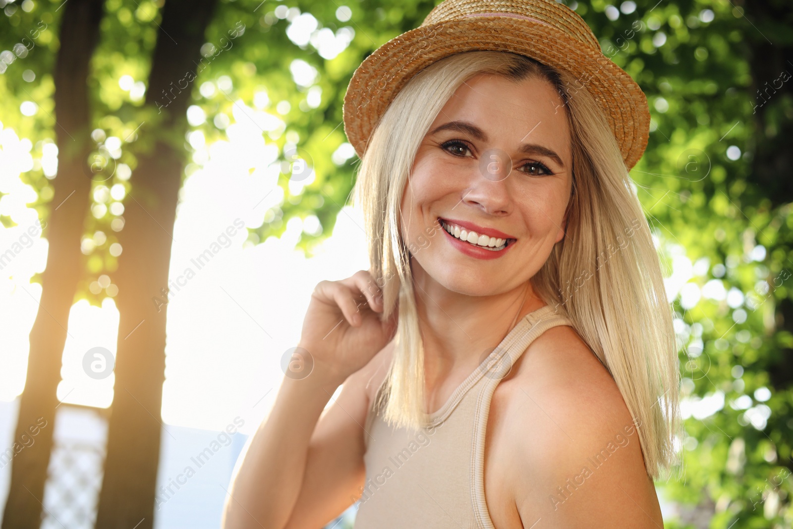 Photo of Portrait of beautiful woman in straw hat outdoors on sunny day