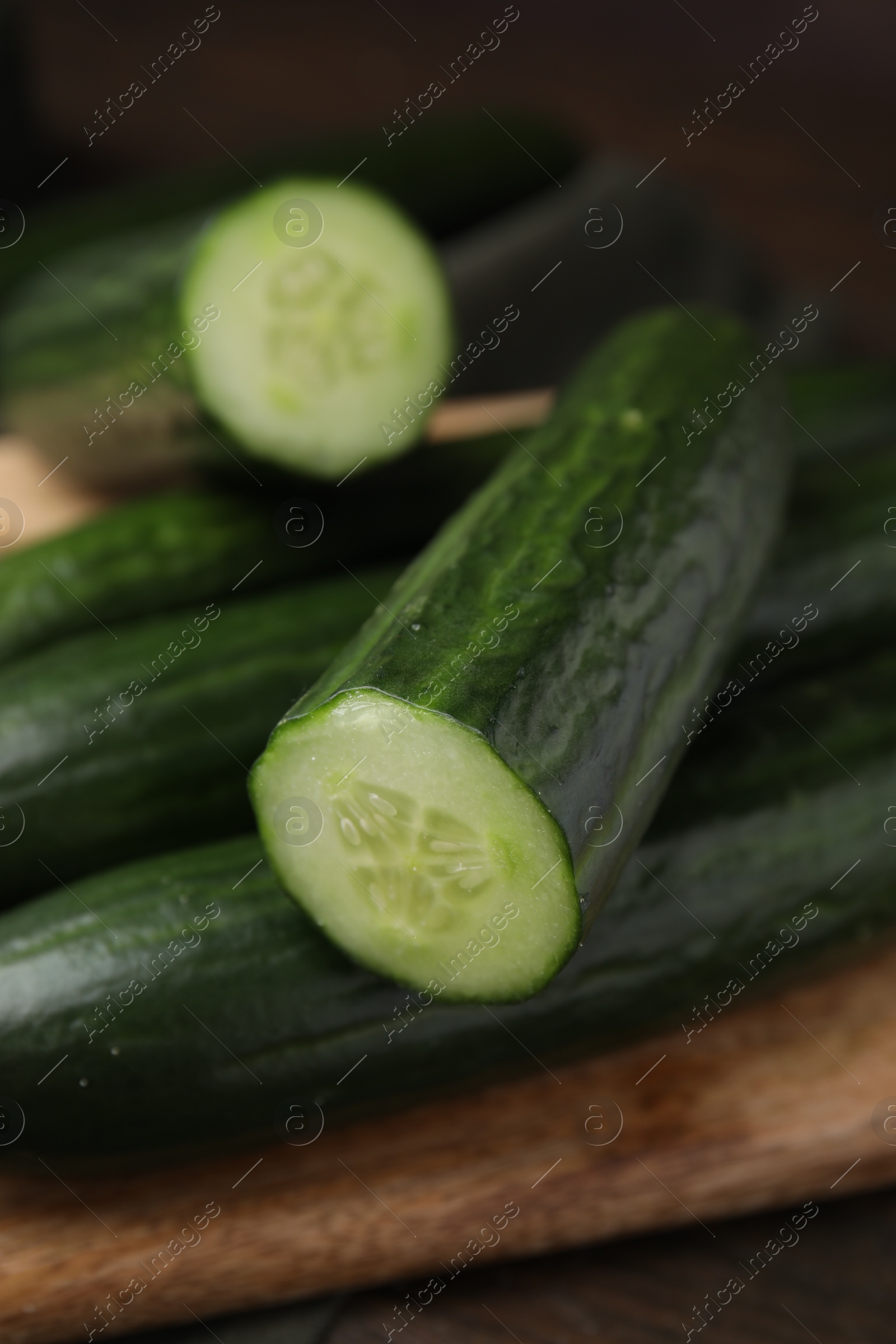 Photo of Many fresh cucumbers on wooden table, closeup