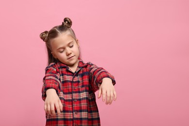 Girl in pajamas sleepwalking on pink background, space for text