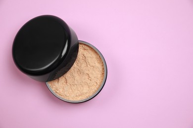 Photo of One face powder on pink background, top view with space for text