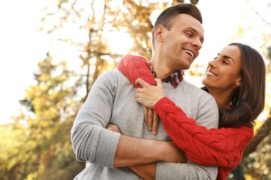 Photo of Happy couple in sunny park. Autumn walk