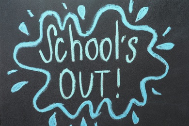 Text School's Out written on black chalkboard. Summer holidays