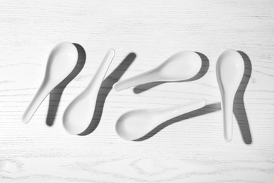 Photo of Flat lay composition with miso soup spoons on white wooden table