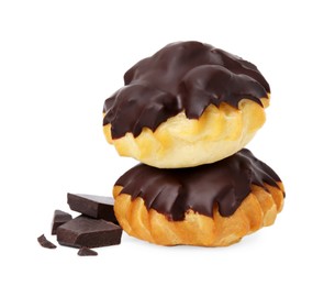 Delicious profiteroles and chocolate isolated on white