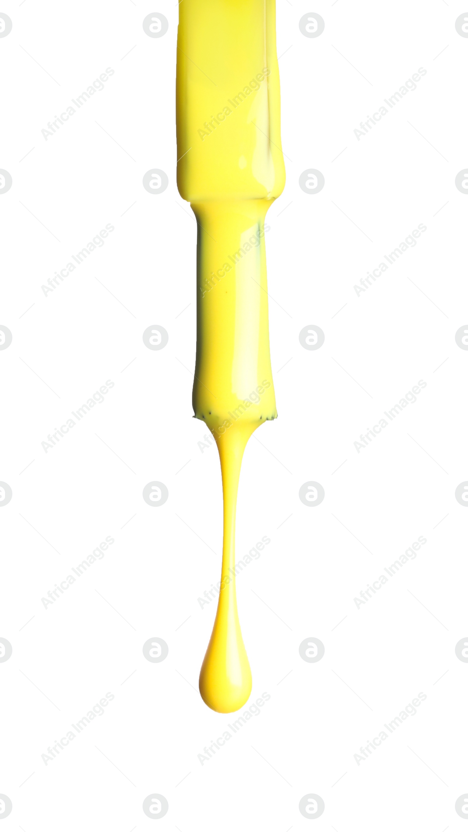 Photo of Yellow nail polish dripping from brush isolated on white