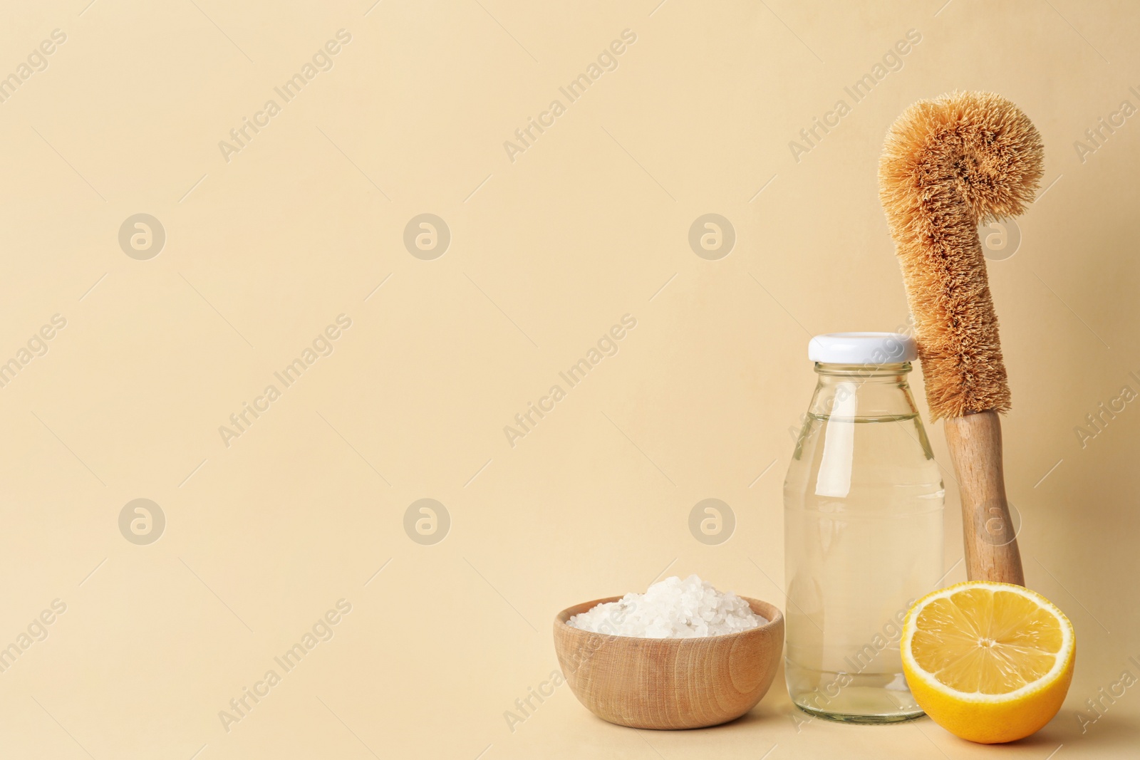 Photo of Eco friendly cleaning supplies for washing dishes on beige background. Conscious consumption