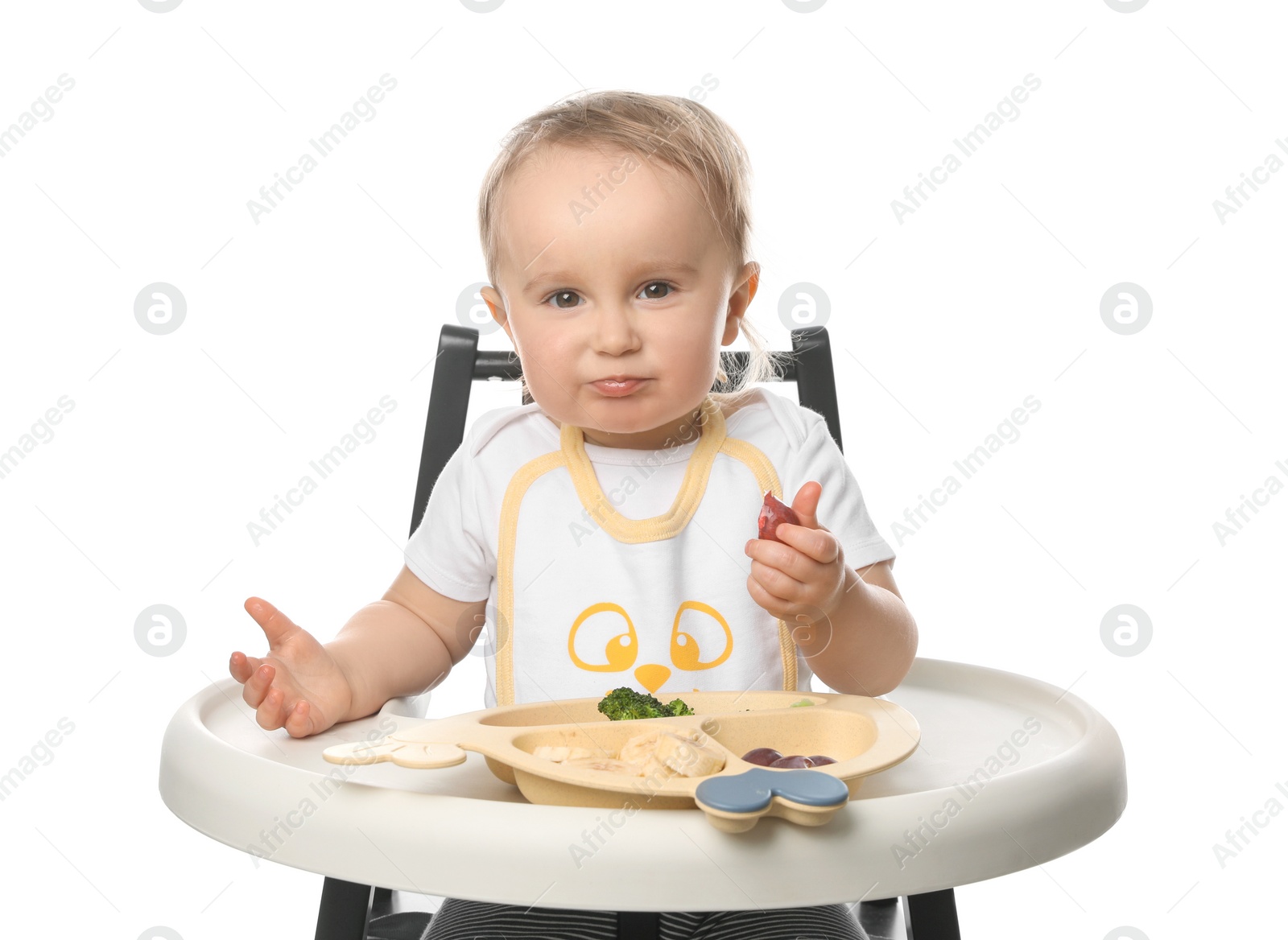 Photo of Cute little baby wearing bib while eating on white background