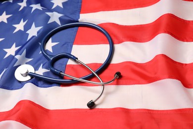Photo of Stethoscope on USA flag, closeup. Health care concept