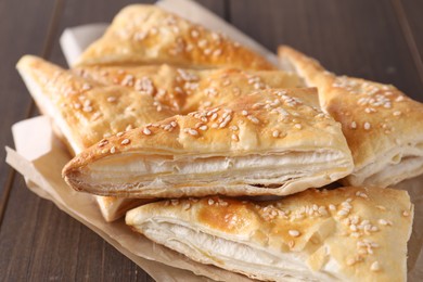 Delicious puff pastry on wooden table, closeup