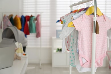Baby clothes hanging on rack in store. Shopping concept