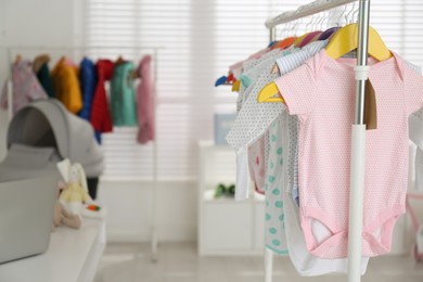 Photo of Baby clothes hanging on rack in store. Shopping concept