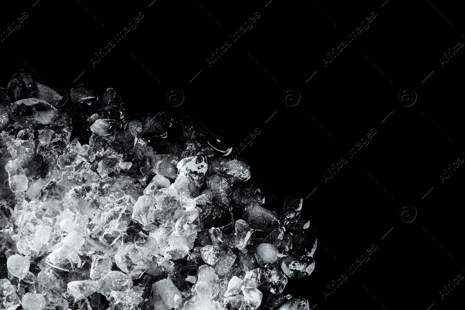 Photo of Heap of crushed ice on black table, top view. Space for text