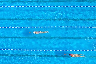 Image of People training in swimming pool, top view