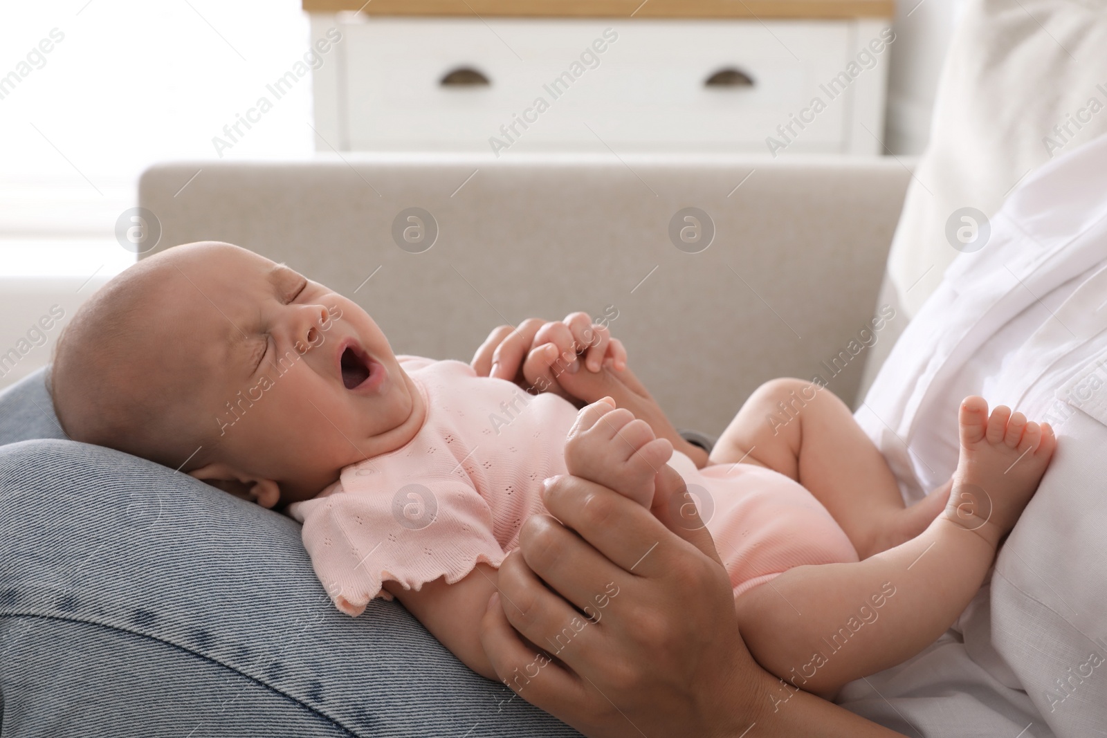 Photo of Mother with her cute sleepy baby at home, closeup