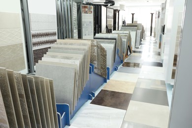 Photo of Assortment of tiles in store. Many different samples indoors