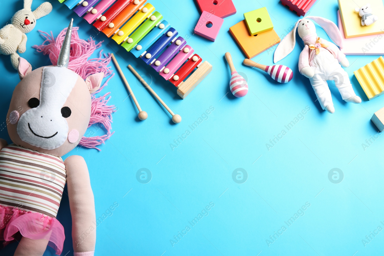 Photo of Flat lay composition with different toys on light blue background. Space for text