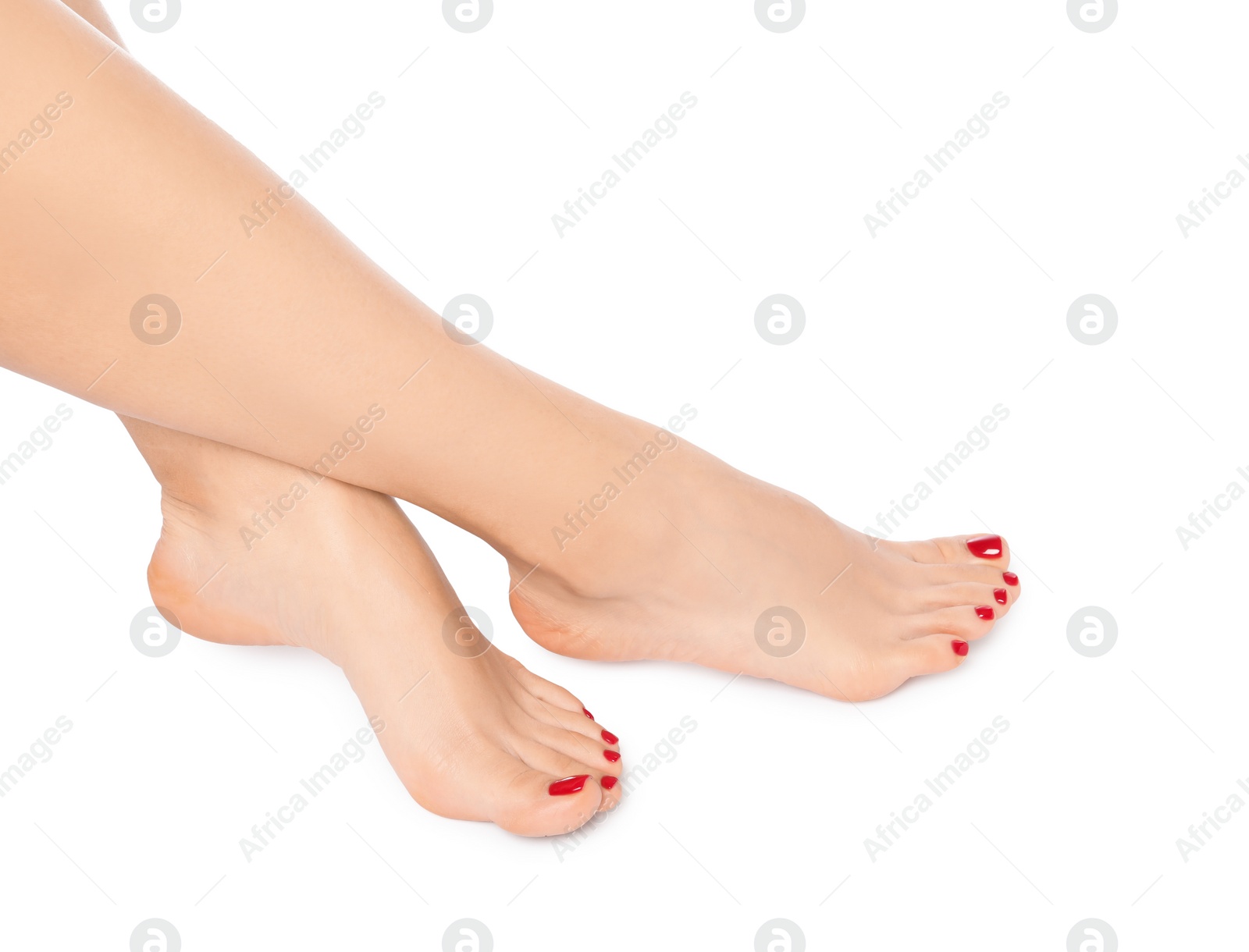 Photo of Woman with stylish red toenails after pedicure procedure isolated on white, closeup