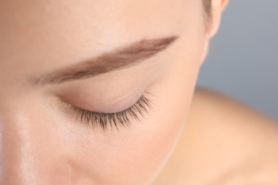 Photo of Young woman with beautiful natural eyelashes, closeup