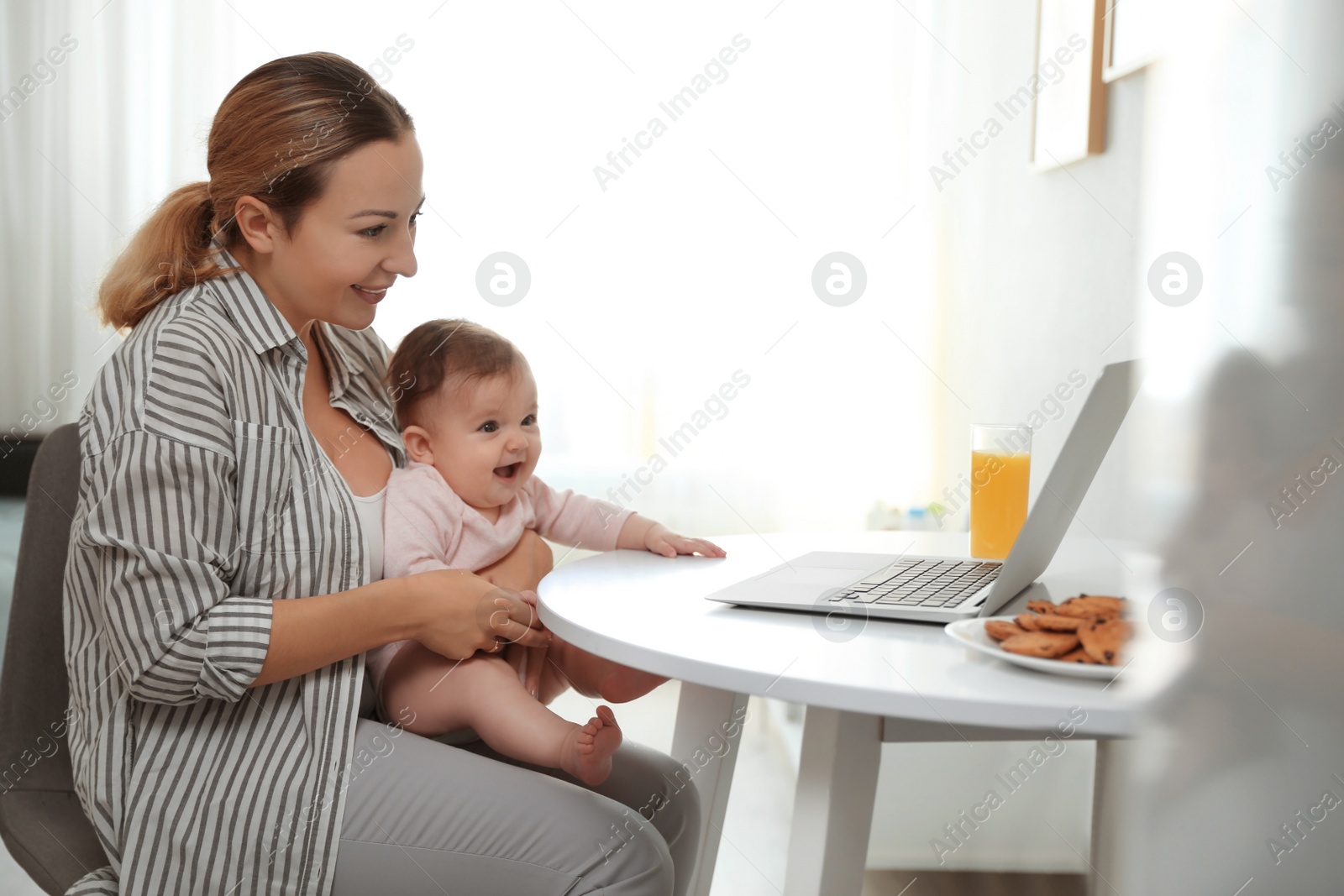 Photo of Young woman with her cute baby at home