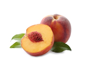 Photo of Whole and cut ripe peaches with leaves isolated on white