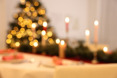 Photo of Blurred view of festive table setting and beautiful Christmas decor indoors. Interior design