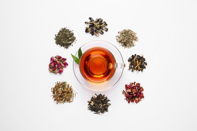 Photo of Composition with brewed tea, dry and fresh leaves on white background, top view