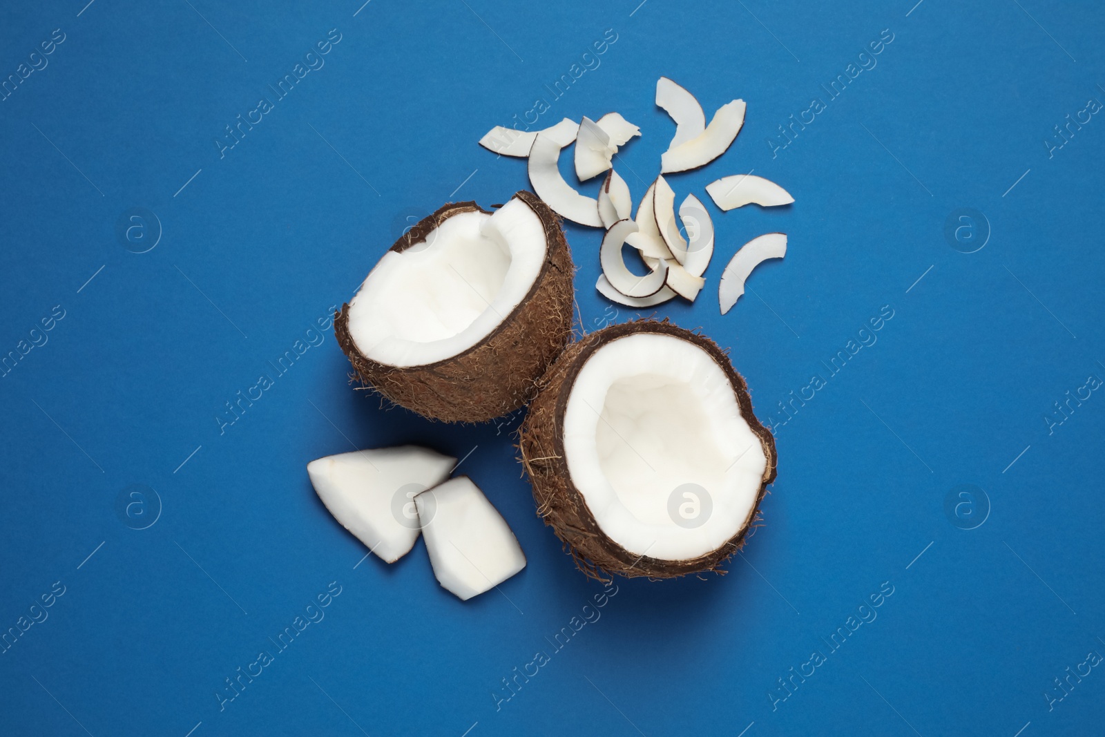 Photo of Flat lay composition with tasty coconut chips on blue background