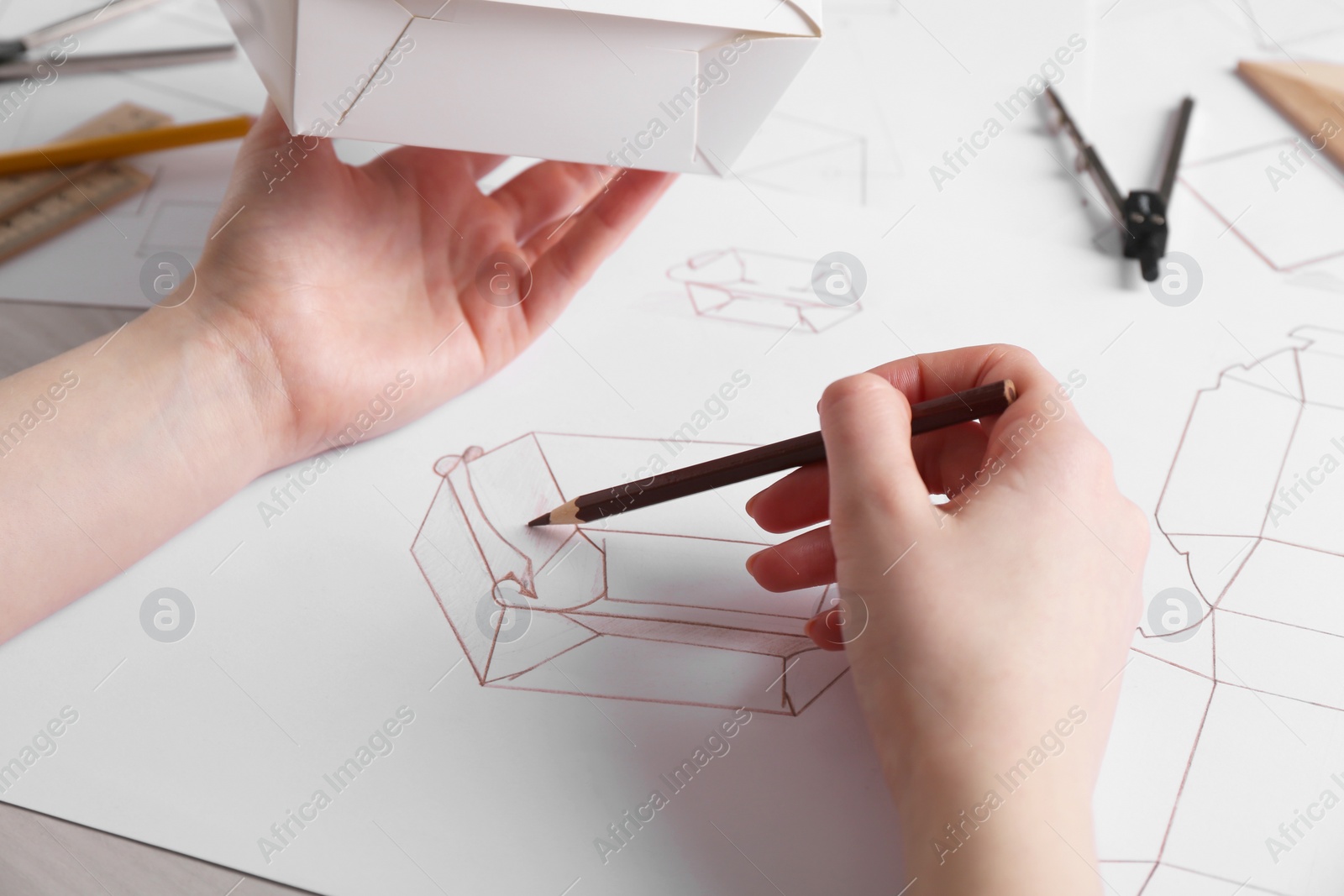 Photo of Woman creating packaging design at table, closeup