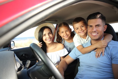 Photo of Happy family in car on road trip