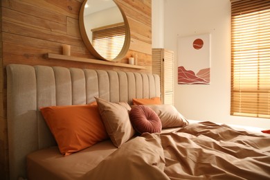 Photo of Bed with brown linens in cozy bedroom. Interior design