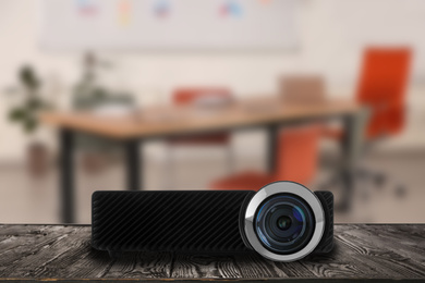 Image of Modern video projector and blurred conference room interior on background
