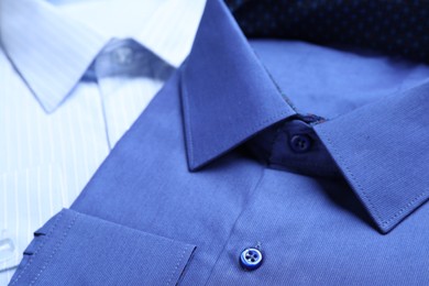 Photo of Closeup view of stylish shirts. Dry-cleaning service