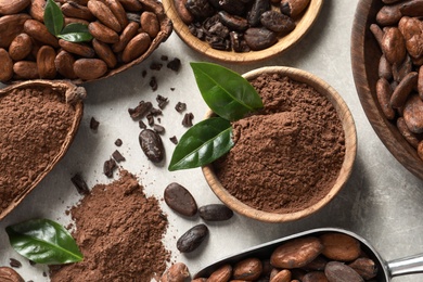 Cocoa pods, beans and powder on light table, flat lay