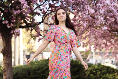 Photo of Beautiful woman near blossoming tree on spring day