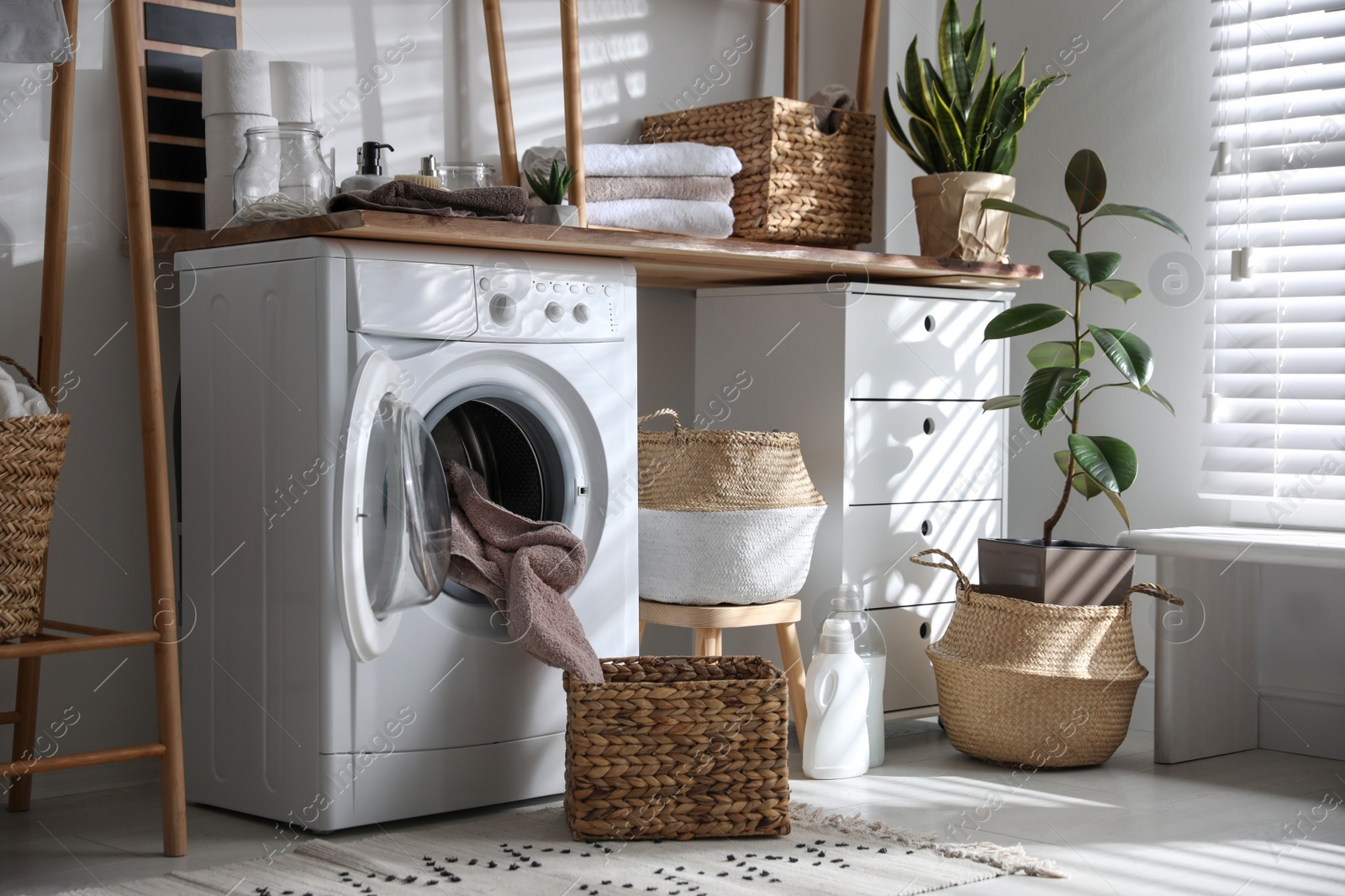 Photo of Stylish bathroom interior with modern washing machine