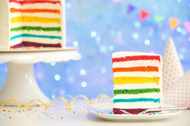 Photo of Delicious rainbow cake for party on table