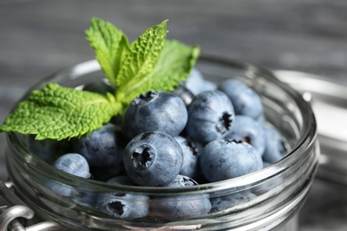Photo of Jar with juicy and fresh blueberries, closeup