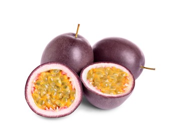 Cut and whole passion fruits on white background