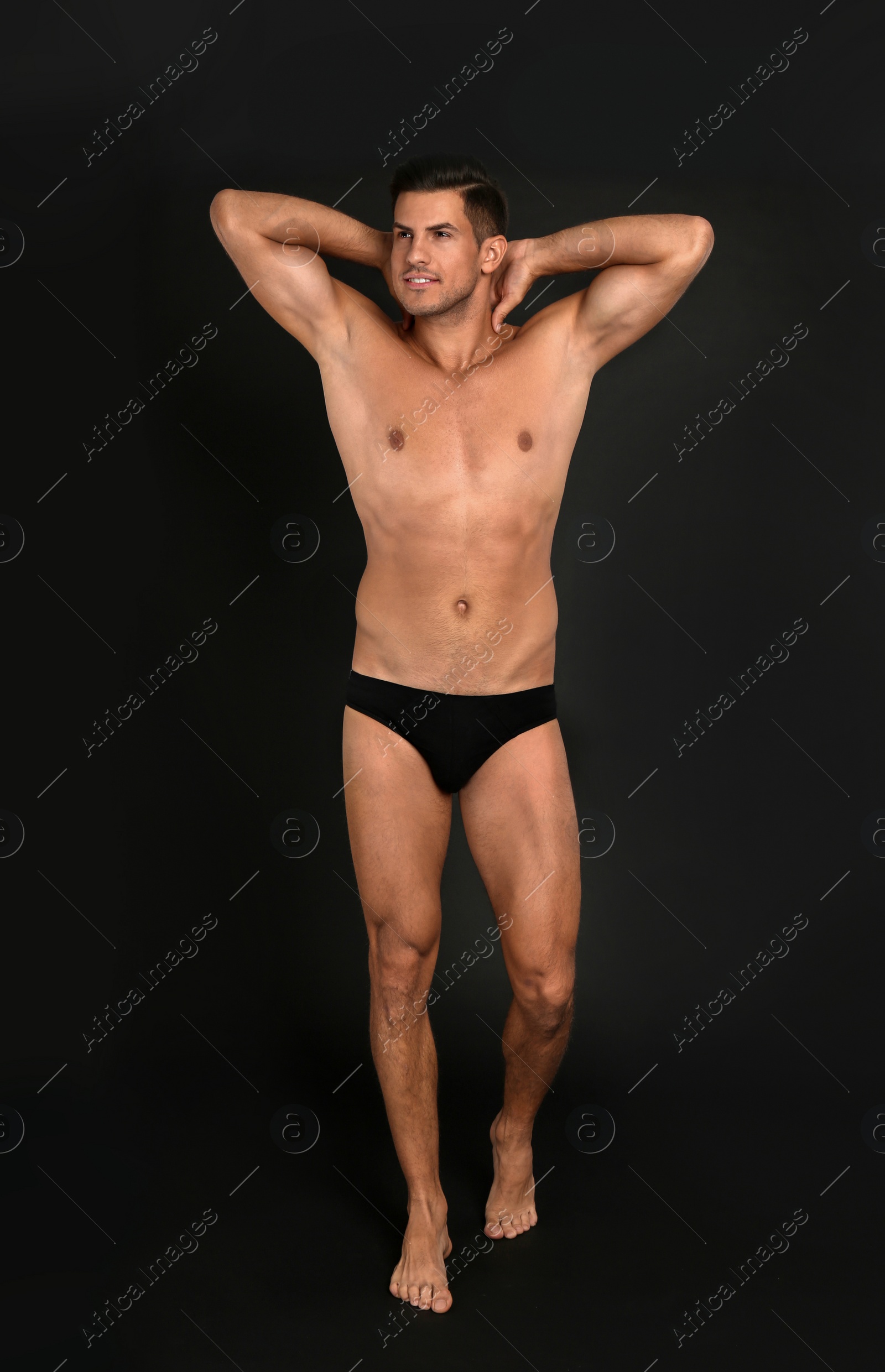 Photo of Handsome man in underwear on black background