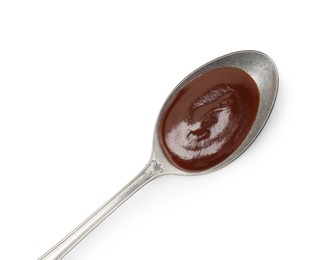 Photo of Tasty barbecue sauce in spoon isolated on white, top view