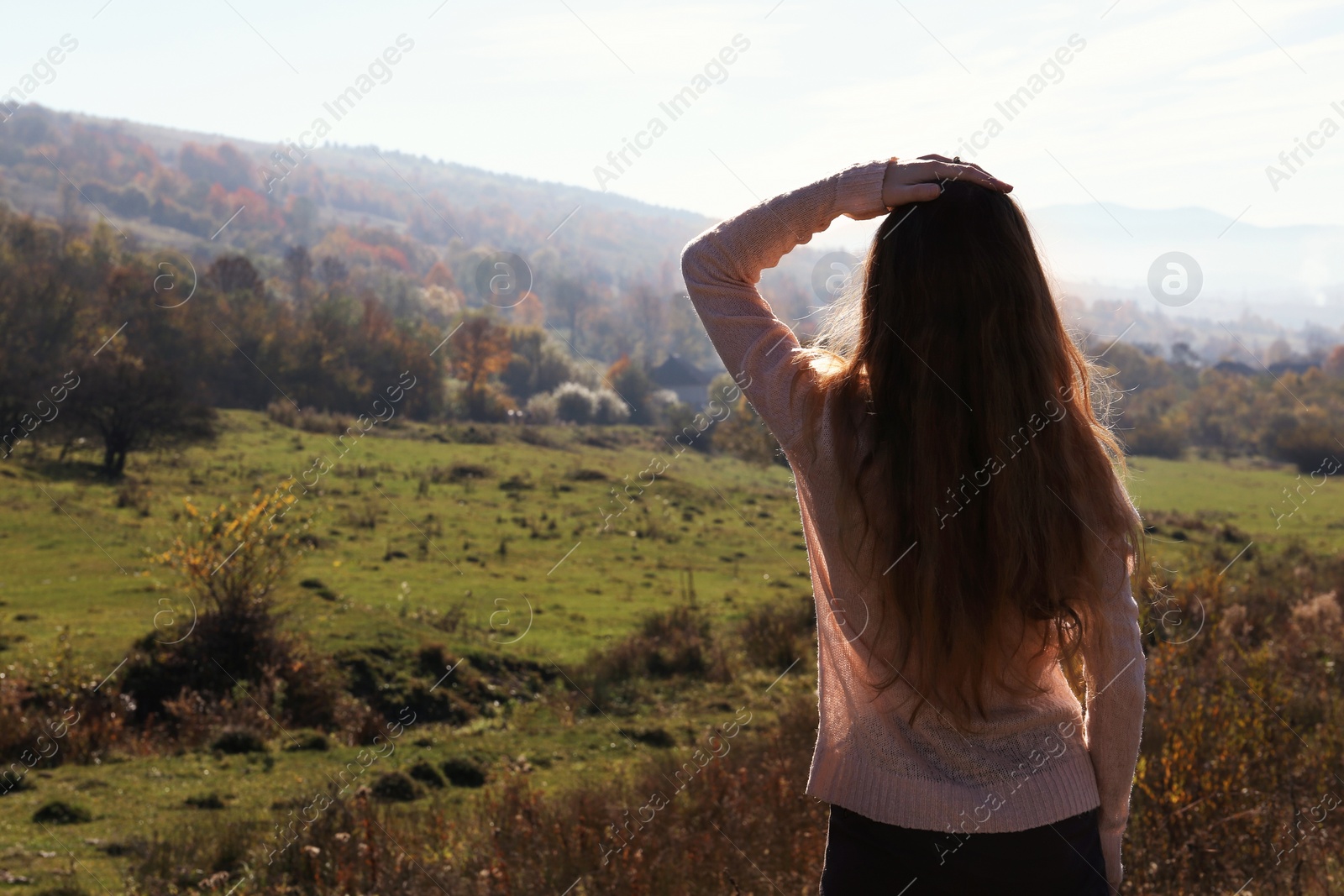 Photo of Female traveler viewing peaceful mountain landscape