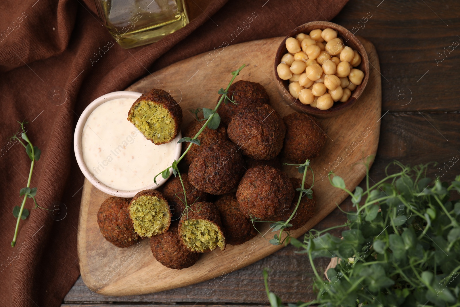 Photo of Delicious falafel balls served on wooden table, top view