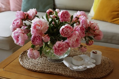 Beautiful pink peonies in vase on table at home. Interior design