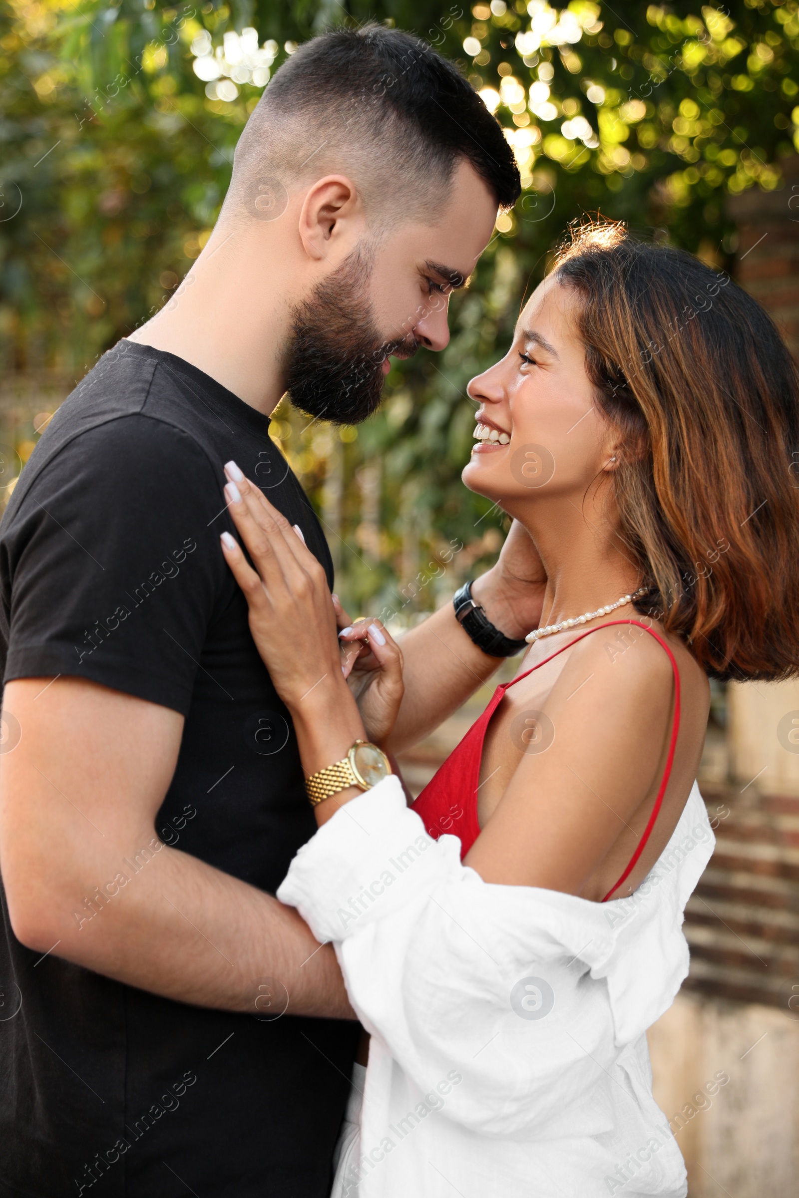 Photo of Happy young couple hugging on city street