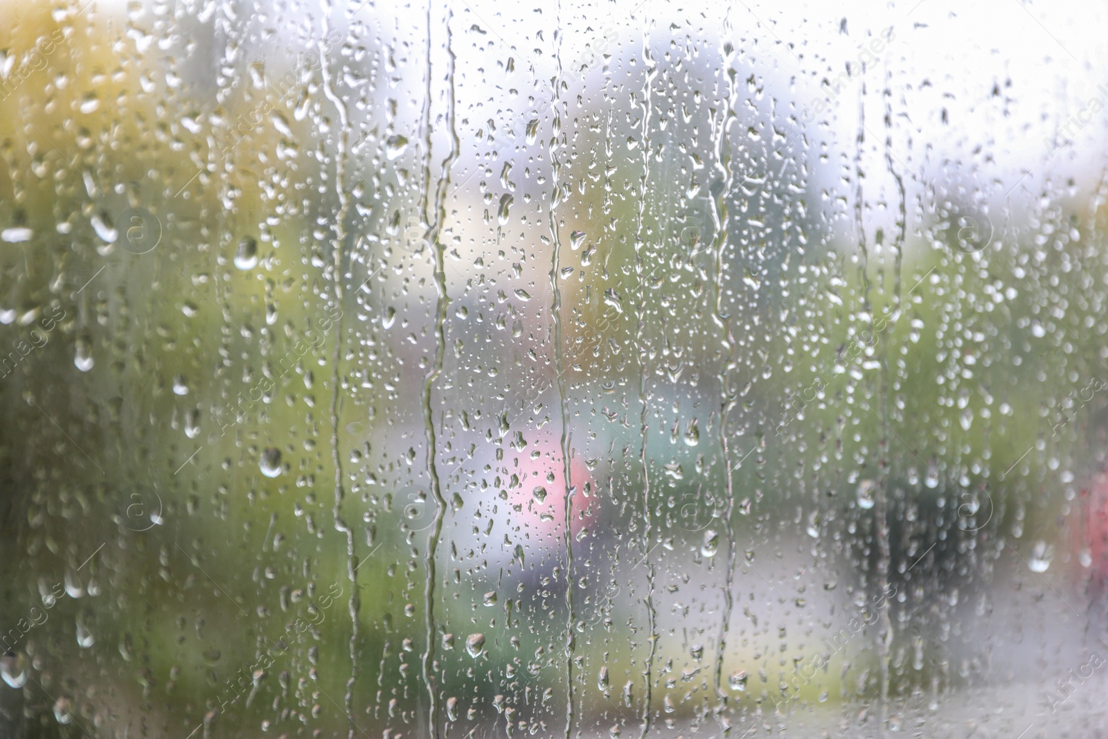 Photo of Window glass with water drops, closeup. Rainy weather