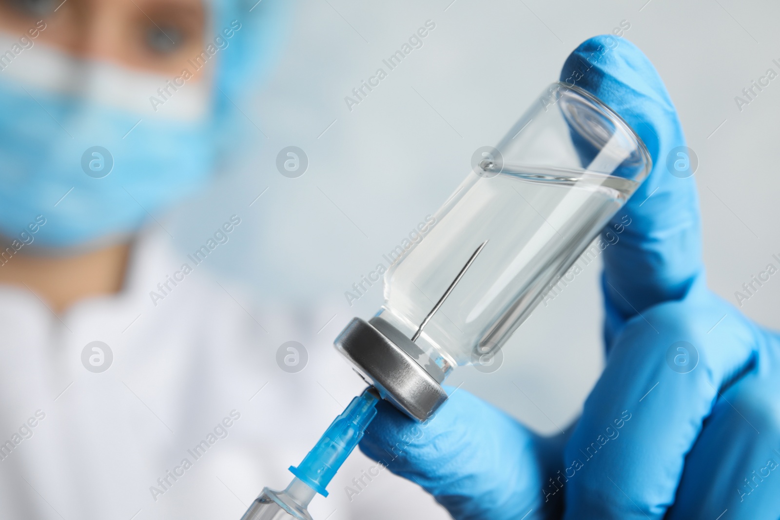 Photo of Doctor filling syringe with medication, closeup. Vaccination and immunization