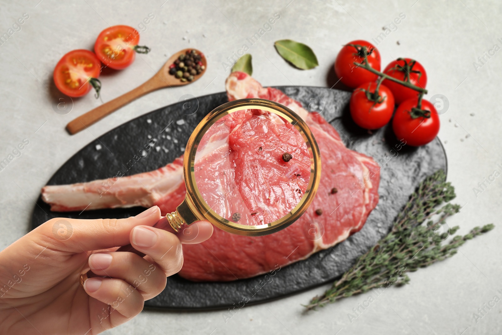 Image of Woman with magnifying glass focusing on fresh raw meat, closeup. Food control 