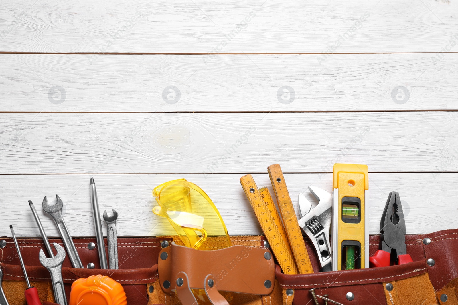 Photo of Flat lay composition with different construction tools and space for text on white wooden background