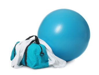 Photo of Fitness ball, gym bag and towel isolated on white