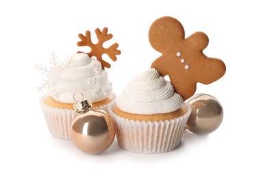 Tasty Christmas cupcakes with gingerbread man, snowflakes and baubles on white background